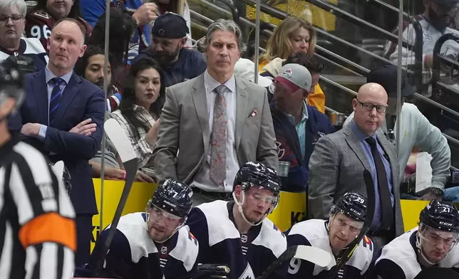 Colorado Avalanche head coach Jared Bednar, top center, looks on with assistant coach Ray Bennet, upper right, and Nolan Pratt, upper left, in the second period of an NHL hockey game against the Winnipeg Jets, Saturday, April 13, 2024, in Denver. (AP Photo/David Zalubowski)