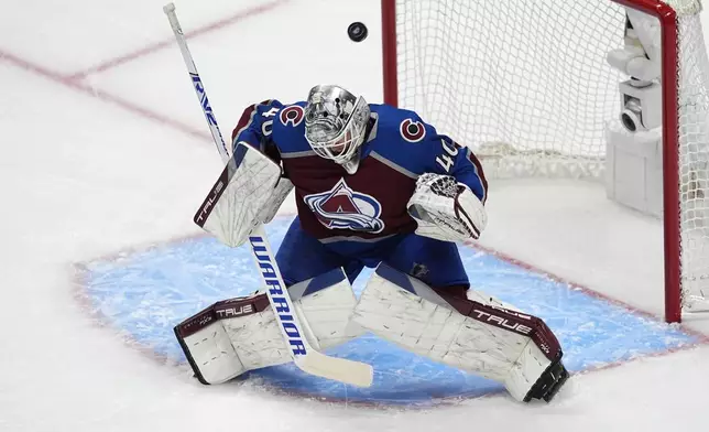 Colorado Avalanche goaltender Alexandar Georgiev stops a shot in the first period of Game 4 of an NHL Stanley Cup first-round playoff series against the Winnipeg Jets, Sunday, April 28, 2024, in Denver. (AP Photo/David Zalubowski)