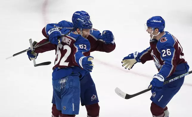 Colorado Avalanche left wing Artturi Lehkonen, front left, celebrates after scoring a goal with left wing Zach Parise, back left, and defenseman Sean Walker, right, in the first period of Game 4 of an NHL Stanley Cup first-round playoff series against the Winnipeg Jets, Sunday, April 28, 2024, in Denver. (AP Photo/David Zalubowski)