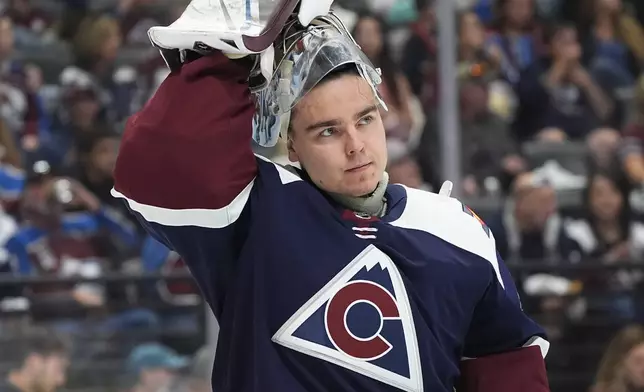 Colorado Avalanche goaltender Justus Annunen pulls on his helmet after a timeout in the second period of an NHL hockey game against the Winnipeg Jets, Saturday, April 13, 2024, in Denver. (AP Photo/David Zalubowski)