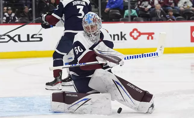 Colorado Avalanche goaltender Justus Annunen, foreground, makes pad-save of a shot in the second period of an NHL hockey game against the Winnipeg Jets, Saturday, April 13, 2024, in Denver. (AP Photo/David Zalubowski)