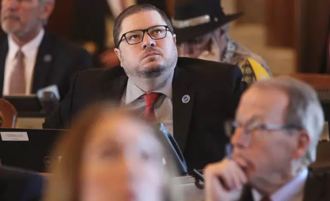 Kansas state Rep. Nick Hoheisel, R-Wichita, watches an electronic tally board as the House votes on legislation, Wednesday, March 27, 2024, at the Statehouse in Topeka, Kan. The Kansas House has a new plan for cutting taxes and has backed off a previous GOP proposal for a "flat" personal income tax with a single rate rather than the current three rates. (AP Photo/John Hanna)