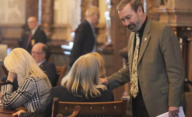 Kansas Sen. Virgil Peck, R-Havana, right, confers with Sen. Molly Baumgardner, R-Louisburg, during the Senate's session, Wednesday, March 27, 2024, at the Statehouse in Topeka, Kan. Senators have included provisions in their proposed state budget on immigration and diversity, equity and inclusion initiatives at state universities. (AP Photo/John Hanna)