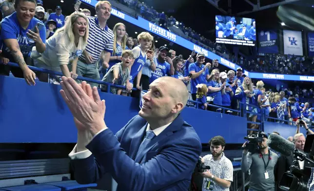 Mark Pope greets fans after being named head coach of the Kentucky men's basketball team in Lexington, Ky., Sunday, April 14, 2024. (AP Photo/James Crisp)