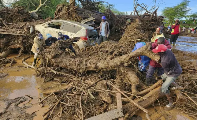 People try to clear the area after a dam burst, in Kamuchiri Village Mai Mahiu, Nakuru County, Kenya, Monday, April 29, 2024. Police in Kenya say at least 40 people have died after a dam collapsed in the country's west. (AP Photo)