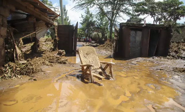 A chair stuck in the muddy water after a dam burst, in Kamuchiri Village, Mai Mahiu, Nakuru County, Kenya, Monday, April 29, 2024. Police in Kenya say at least 40 people have died after a dam collapsed in the country's west. (AP Photo/Patrick Ngugi)