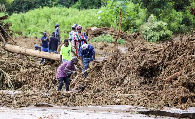 People try to clear the area after a dam burst, in Kamuchiri Village Mai Mahiu, Nakuru County, Kenya, Monday, April 29, 2024. Kenya's Interior Ministry says at least 45 people have died and dozens are missing after a dam collapsed following heavy rains. (AP Photo/Patrick Ngugi)