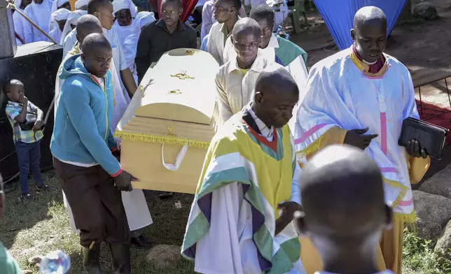 Friends and family carry the casket of Rose Bella Awuor, 31 years, after a funeral service at her home in Awendo, Migori County, Kenya Thursday, April. 11, 2024. Awuor fell ill in December and lost her five-month pregnancy before succumbing to malaria. It was the latest of five deaths in this family attributed to malaria. The disease is endemic to Kenya and is preventable and curable, but poverty makes it deadly for those who can't afford treatment. (AP Photo/Brian Ongoro)