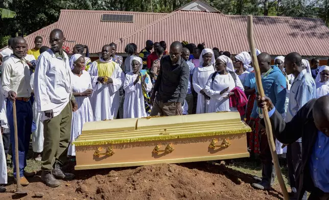 Friends and family prepare to lower the casket of Rose Bella Awuor, 31 years, after a funeral service at her home in Awendo, Migori County, Kenya Thursday, April. 11, 2024. Awuor fell ill in December and lost her five-month pregnancy before succumbing to malaria. It was the latest of five deaths in this family attributed to malaria. The disease is endemic to Kenya and is preventable and curable, but poverty makes it deadly for those who can't afford treatment. (AP Photo/Brian Ongoro)