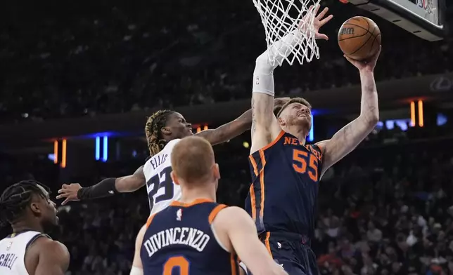 New York Knicks' Isaiah Hartenstein (55) drives past Sacramento Kings' Keon Ellis (23) during the first half of an NBA basketball game Thursday, April 4, 2024, in New York. (AP Photo/Frank Franklin II)