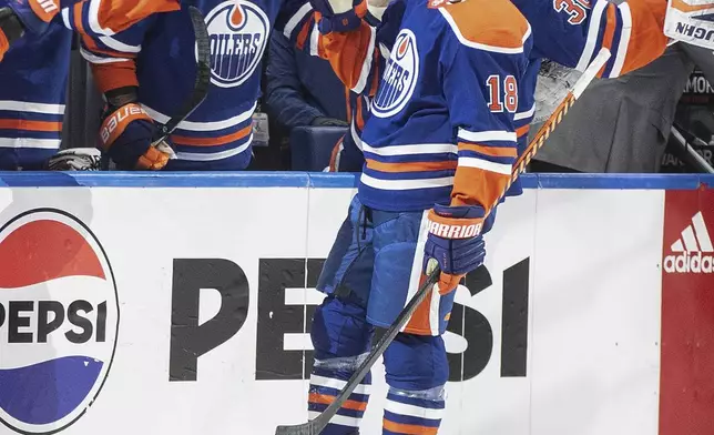 Edmonton Oilers' Zach Hyman (18) celebrates his hat trick against the Los Angeles Kings during the third period of Game 1 in first-round NHL Stanley Cup playoff hockey action in Edmonton, Alberta, Monday, April 22, 2024. (Jason Franson/The Canadian Press via AP)