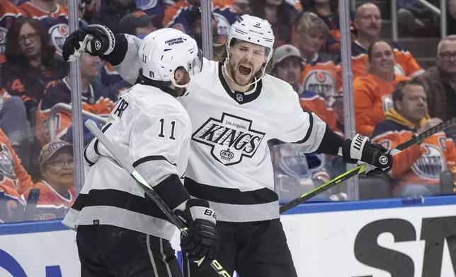 Los Angeles Kings' Adrian Kempe (9) and Anze Kopitar (11) celebrate a goal against the Edmonton Oilers during the first period of Game 2 of an NHL hockey Stanley Cup first-round playoff series Wednesday, April 24, 2024, in Edmonton, Alberta. (Jason Franson/The Canadian Press via AP)