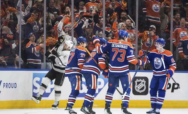 Los Angeles Kings' Trevor Lewis (61) skates past as the Edmonton Oilers celebrate a goal during the first period of Game 2 of an NHL hockey Stanley Cup first-round playoff series Wednesday, April 24, 2024, in Edmonton, Alberta. (Jason Franson/The Canadian Press via AP)