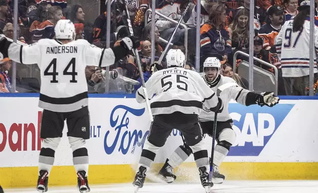 Los Angeles Kings' Mikey Anderson (44), Quinton Byfield (55) and Anze Kopitar (11) celebrate Kopitar's overtime goal against the Edmonton Oilers in Game 2 of an NHL hockey Stanley Cup first-round playoff series Wednesday, April 24, 2024, in Edmonton, Alberta. (Jason Franson/The Canadian Press via AP)