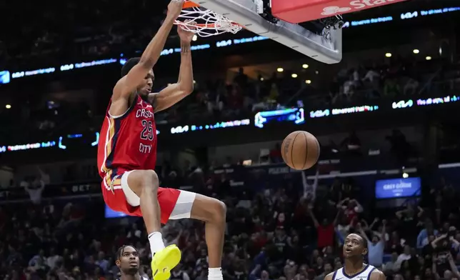 New Orleans Pelicans guard Trey Murphy III (25) slam dunks in the second half of an NBA basketball play-in tournament game against the Sacramento Kings in New Orleans, Friday, April 19, 2024. The Pelicans won 105-98. (AP Photo/Gerald Herbert)