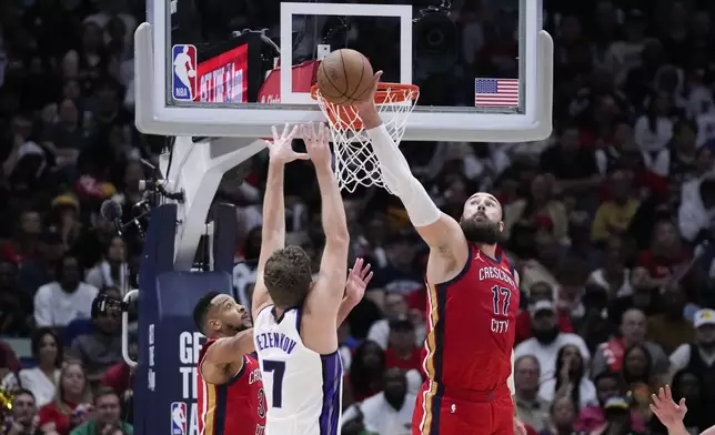 New Orleans Pelicans center Jonas Valanciunas (17) blocks a shot by Sacramento Kings forward Sasha Vezenkov (7) in the second half of an NBA basketball play-in tournament game in New Orleans, Friday, April 19, 2024. The Pelicans won 105-98. (AP Photo/Gerald Herbert)