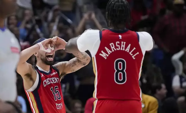 New Orleans Pelicans guard Jose Alvarado (15) celebrates with forward Naji Marshall (8) in the second half of an NBA basketball play-in tournament game in New Orleans, Friday, April 19, 2024. The Pelicans won 105-98. (AP Photo/Gerald Herbert)