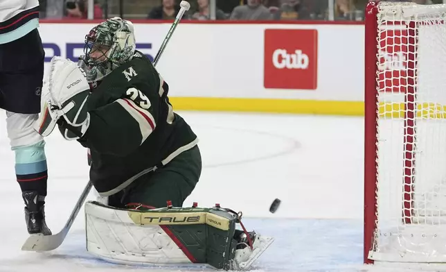 Minnesota Wild goaltender Marc-Andre Fleury gives up a goal to Seattle Kraken center Matty Beniers during the second period of an NHL hockey game Thursday, April 18, 2024, in St. Paul, Minn. (AP Photo/Abbie Parr)