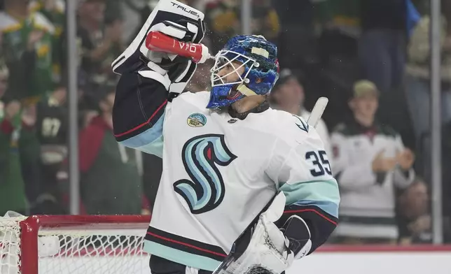 Seattle Kraken goaltender Joey Daccord douses himself with water after a goal scored by Minnesota Wild left wing Kirill Kaprizov during the first period of an NHL hockey game Thursday, April 18, 2024, in St. Paul, Minn. (AP Photo/Abbie Parr)