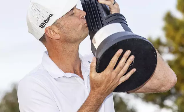 Individual Champion Brendan Steele of HyFlyers GC kisses the trophy after the final round of LIV Golf Adelaide at the Grange Golf Club on Sunday, April 28, 2024, in Adelaide, Australia. (Chris Trotman/LIV Golf via AP)