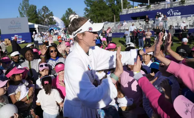 Nelly Korda high-fives young fans while celebrating her win at the Chevron Championship LPGA golf tournament Sunday, April 21, 2024, at The Club at Carlton Woods in The Woodlands, Texas. (AP Photo/Eric Gay)