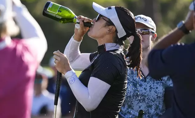 Hannah Green drinks champagne after winning the LPGA's JM Eagle LA Championship golf tournament at Wilshire Country Club, Sunday, April 28, 2024, in Los Angeles. (AP Photo/Ashley Landis)