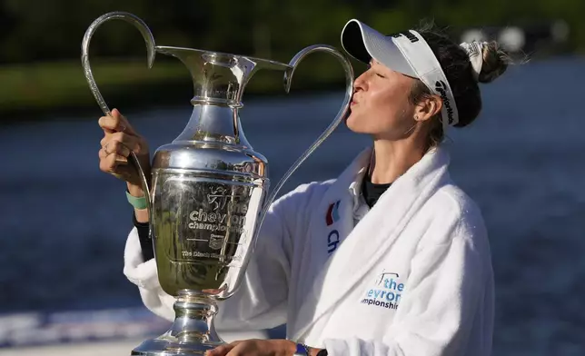 Nelly Korda kisses the trophy while posing for photos after winning the Chevron Championship LPGA golf tournament Sunday, April 21, 2024, at The Club at Carlton Woods in The Woodlands, Texas. (AP Photo/David J. Phillip)