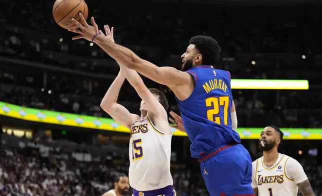Denver Nuggets guard Jamal Murray (27) goes up to shoot against Los Angeles Lakers guard Austin Reaves (15) during the second half in Game 1 of an NBA basketball first-round playoff series Saturday, April 20, 2024, in Denver. (AP Photo/Jack Dempsey)