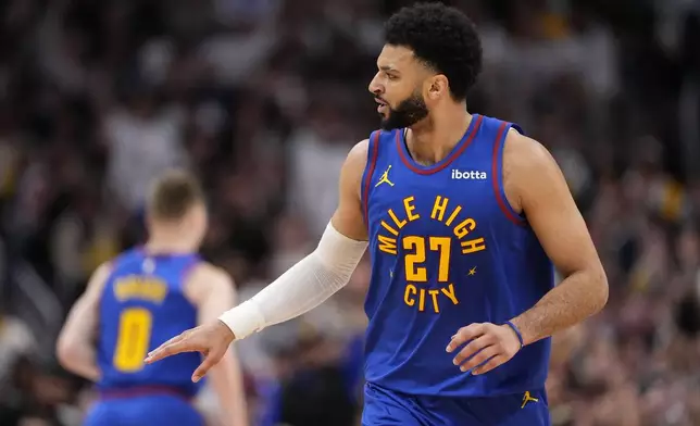 Denver Nuggets guard Jamal Murray celebrates after a 3-point basket against the Los Angeles Lakers during the first half in Game 1 of an NBA basketball first-round playoff series Saturday, April 20, 2024, in Denver. (AP Photo/Jack Dempsey)