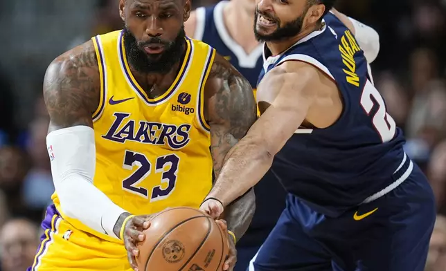Los Angeles Lakers forward LeBron James, left, fields a pass as Denver Nuggets guard Jamal Murray, right, tries to make a steal in the first half of Game 5 of an NBA basketball first-round playoff series Monday, April 29, 2024, in Denver. (AP Photo/David Zalubowski)