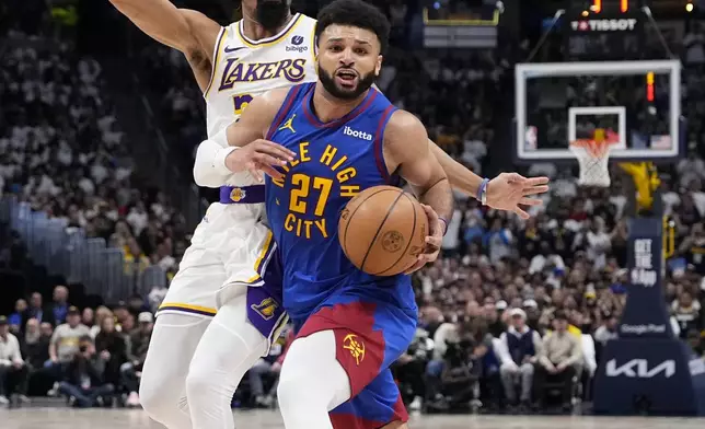 Denver Nuggets guard Jamal Murray (27) drives to the basket against the Los Angeles Lakers during the second half in Game 1 of an NBA basketball first-round playoff series Saturday, April 20, 2024, in Denver. (AP Photo/Jack Dempsey)