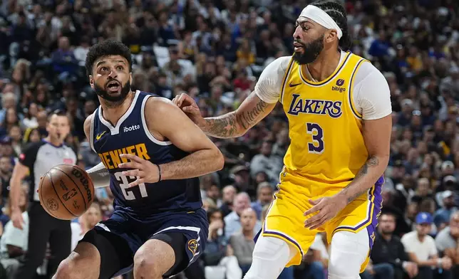 Denver Nuggets guard Jamal Murray, left, drives to the basket as Los Angeles Lakers forward Anthony Davis, right, defends in the first half of Game 5 of an NBA basketball first-round playoff series Monday, April 29, 2024, in Denver. (AP Photo/David Zalubowski)