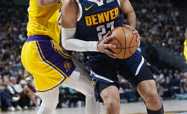 Denver Nuggets guard Jamal Murray, right, drives to the basket as Los Angeles Lakers guard Spencer Dinwiddie, left, defends in the first half of Game 5 of an NBA basketball first-round playoff series Monday, April 29, 2024, in Denver. (AP Photo/David Zalubowski)