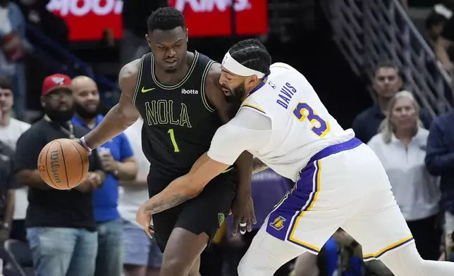 New Orleans Pelicans forward Zion Williamson (1) works the ball against Los Angeles Lakers forward Anthony Davis (3) in the first half of an NBA basketball game in New Orleans, Sunday, April 14, 2024. (AP Photo/Gerald Herbert)