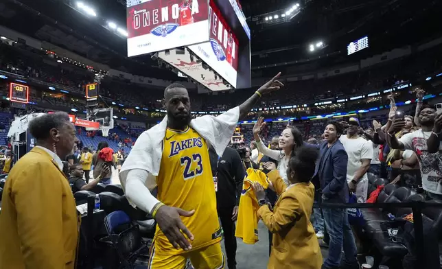 Los Angeles Lakers forward LeBron James (23) acknowledges fans as he leaves the court after an NBA basketball play-in tournament game against the New Orleans Pelicans, Tuesday, April 16, 2024, in New Orleans. The Lakers won 110-106. (AP Photo/Gerald Herbert)