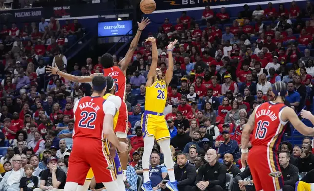Los Angeles Lakers guard Spencer Dinwiddie (26) shoots against New Orleans Pelicans forward Herbert Jones in the first half of an NBA basketball play-in tournament game Tuesday, April 16, 2024, in New Orleans. (AP Photo/Gerald Herbert)
