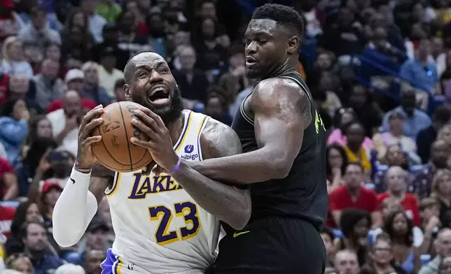 Los Angeles Lakers forward LeBron James (23) drives to the basket against New Orleans Pelicans forward Zion Williamson in the first half of an NBA basketball game in New Orleans, Sunday, April 14, 2024. (AP Photo/Gerald Herbert)