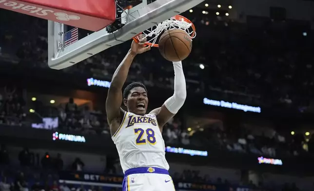 Los Angeles Lakers forward Rui Hachimura (28) slam dunks in the first half of an NBA basketball game against the New Orleans Pelicans in New Orleans, Sunday, April 14, 2024. (AP Photo/Gerald Herbert)