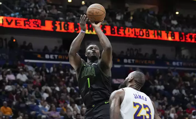 New Orleans Pelicans forward Zion Williamson (1) shoots over Los Angeles Lakers forward LeBron James (23) in the second half of an NBA basketball game in New Orleans, Sunday, April 14, 2024. The Lakers won 124-108. (AP Photo/Gerald Herbert)