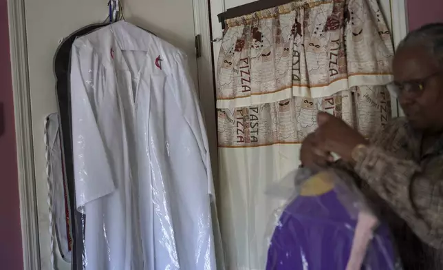 Wendy Owens, a United Methodist Minister and mother of Lama Rod Owens, shows her robes hanging in her home on Saturday, March 30, 2024, in Rome Georgia. (AP Photo/Jessie Wardarski)