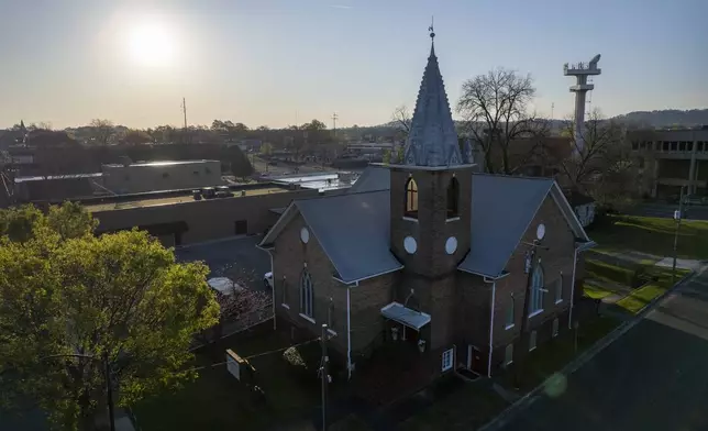 The sun sits behind the Metropolitan United Methodist Church in Rome, Georgia on Sunday, March 31, 2024. This was the local parish Lama Rod Owens attended as a child. Today, he is an influential voice in a new generation of Buddhist teachers. (AP Photo/Jessie Wardarski)