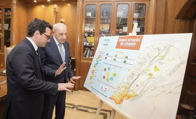 Lebanese Parliament Speaker Nabih Berri, right, shows a map that details Israel's strikes on Lebanon since Oct. 7, to visiting French Foreign Minister Stephane Sejourne during their meeting, in Beirut, Lebanon, Sunday, April 28, 2024. (AP Photo/Hassan Ammar)
