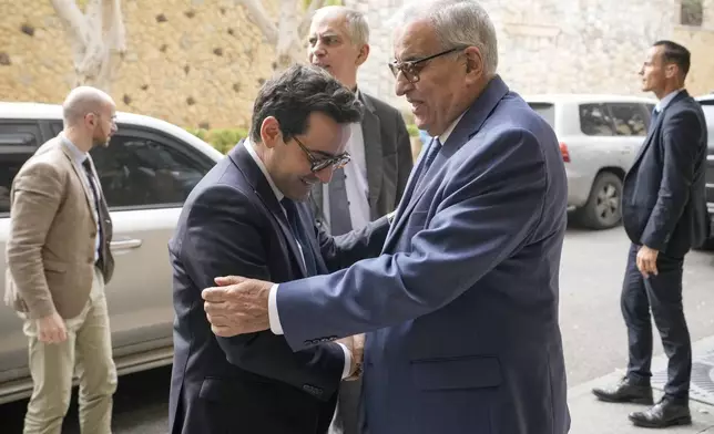 Lebanese Foreign Minister Abdallah Bouhabib, right, welcomes his French counterpart Stephane Sejourne, during their meeting, in Beirut, Lebanon, Sunday, April 28, 2024. (AP Photo/Hassan Ammar)