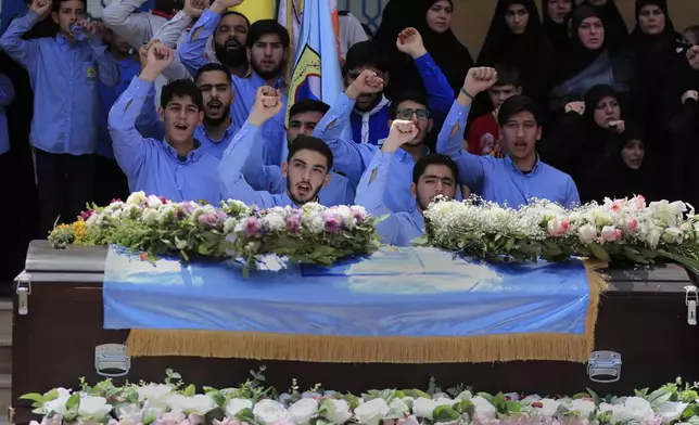 Students shout slogans as they stand in front the coffin of a 10-year-old girl was killed Tuesday by an Israeli strike on a house in the town of Hanin, during her funeral procession at the backyard of Hezbollah-run Al-Mahdi school, in Tiri village, south Lebanon, April 25, 2024. Hezbollah militants and Israeli forces have been exchanging fire since a day after the Israel-Hamas war began on Oct. 7. (AP Photo/Mohammed Zaatari)