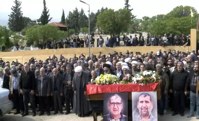 In this grab taken from video, mourners pray over the coffin of Lebanese money changer Mohammad Srour, 57, who was found tortured and killed inside a villa in Monte Verdi neighborhood of Beit Meri, during his funeral procession in Labweh village, near the border with Syria, northeast Lebanon, Thursday, April 11, 2024. Lebanon’s interior minister alleged Wednesday that the mysterious abduction and killing of a Hezbollah-linked Lebanese financier in a villa on the edge of a quiet mountain resort town earlier this month was likely the work of Israeli operatives. (AP Photo)