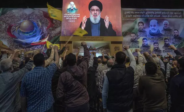 Hezbollah leader Sayyed Hassan Nasrallah speaks in a televised address via a video link during a ceremony to commemorate the death of the Iranian Revolutionary Guard Gen. Mohammad Reza Zahedi and six officers, who were killed by an Israeli airstrike that demolished Iran's consulate in Syria last Monday, in the southern suburbs of Beirut, Lebanon, Monday, April 8, 2024. Nasrallah paid tribute to Zahedi, who spent 12 years of his career as a top general at the Iranian Revolutionary Guards elite Quds Force with Hezbollah. The Hezbollah leader said he played a key role in strengthening and empowering the group which fought several wars with Israel, and has become Iran's key proxy in the region. (AP Photo/Hassan Ammar)
