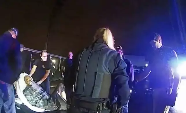 In this image from Altoona Police Department body-camera video, Demetrio Jackson is placed on a gurney after paramedics administered an injection of the sedative ketamine in a parking lot on the border of Altoona and Eau Claire, Wis., on Oct. 8, 2021. Later, Jackson stopped breathing on the way to Sacred Heart Hospital. He'd suffered cardiac arrest and had no brain function. (Altoona Police Department via AP)