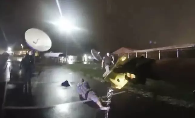 In this image from Altoona Police Department body-camera video, an officer fires a Taser at Demetrio Jackson in a parking lot on the border of Altoona and Eau Claire, Wis., on Oct. 8, 2021. After officers couldn’t handcuff Jackson, the officer fired additional darts. (Altoona Police Department via AP)