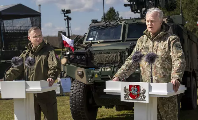 Lithuania's President Gitanas Nauseda, right, speaks during a joint media conference with Poland's President Andrej Duda, during the Lithuanian-Polish Brave Griffin 24/II military exercise near the Suwalki Gap at the Dirmiskes village, Alytus district west of the capital Vilnius in Lithuania on Friday, April 26, 2024. The week-long military exercise which started April 22, is to test a defense scenario on the bilateral so-called “Orsha” plan to defend the Suwałki Gap, a corridor of almost 100 kilometers (62 miles) between the two NATO members Poland and Lithuania. (AP Photo/Mindaugas Kulbis)