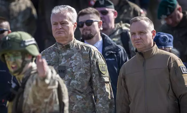 Lithuania's President Gitanas Nausedas and Poland's President Andrej Duda, right, attend a Lithuanian-Polish Brave Griffin 24/II military exercise near the Suwalki Gap near the Polish border at the Dirmiskes village, Alytus district west of the capital Vilnius in Lithuania on Friday, April 26, 2024. Over 1500 troops and 200 pieces of tactical equipment are rehearsing defence scenarios under the bilateral Lithuanian-Polish Orsha Plan near the Suwalki Gap. (AP Photo/Mindaugas Kulbis)
